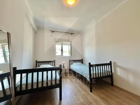 Bedroom with two wooden beds and a window. - image 5