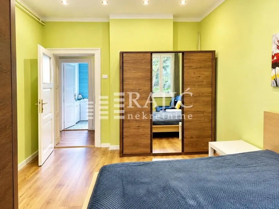 Furnished bedroom with a wardrobe and a double bed.