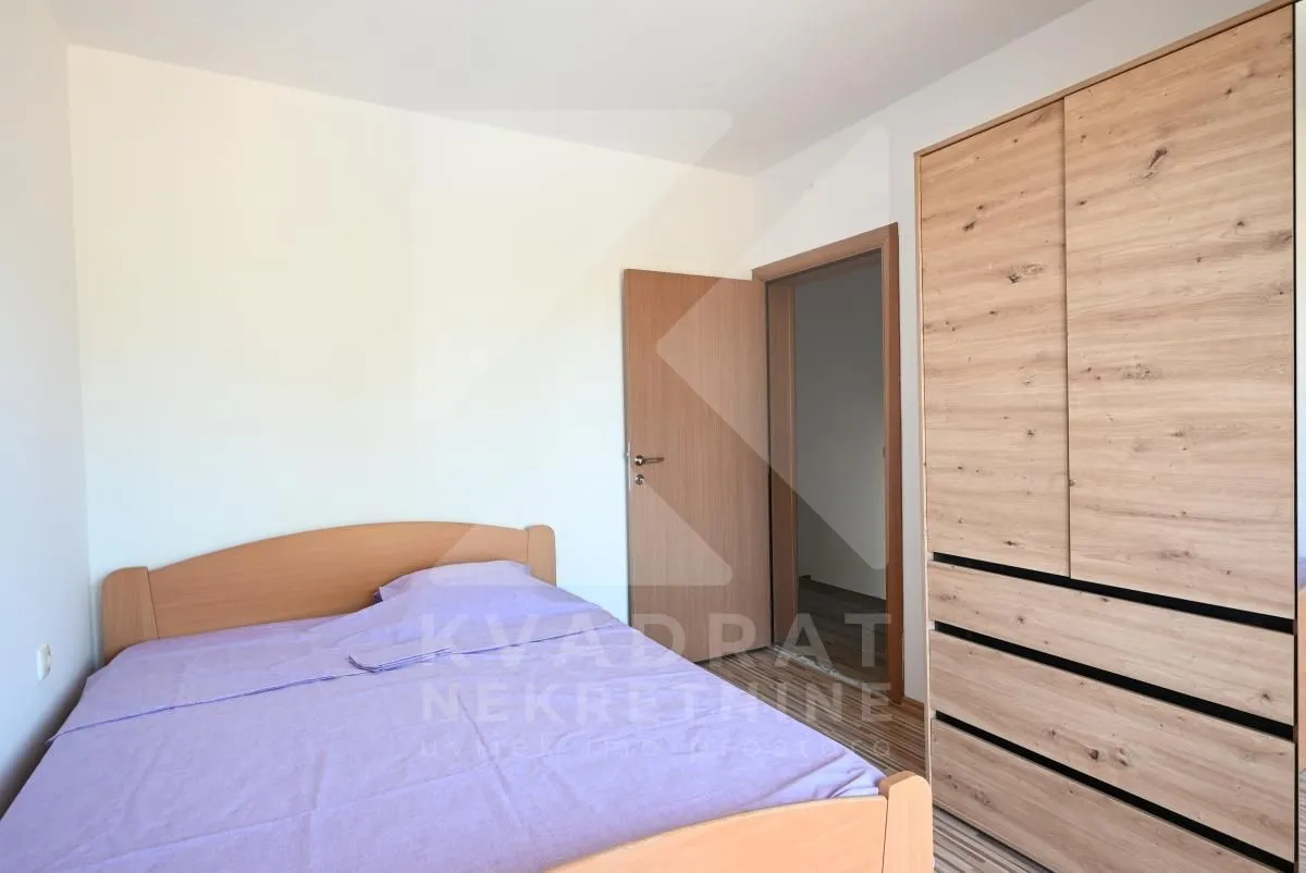 Bedroom with a double bed and wooden wardrobe.
