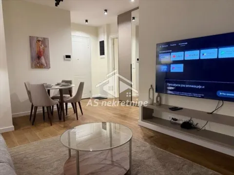 Living room with a dining area and a wall-mounted TV. - image 5