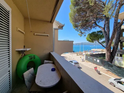Manji namješteni balkon sa stolom i stolicama i pogledom na more. - image 14