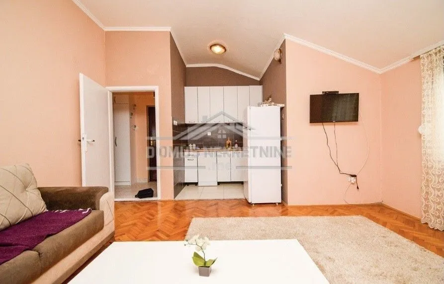 Living room with kitchen in the background.