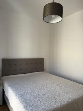 Furnished bedroom with a double bed and hanging lamp. - image 7