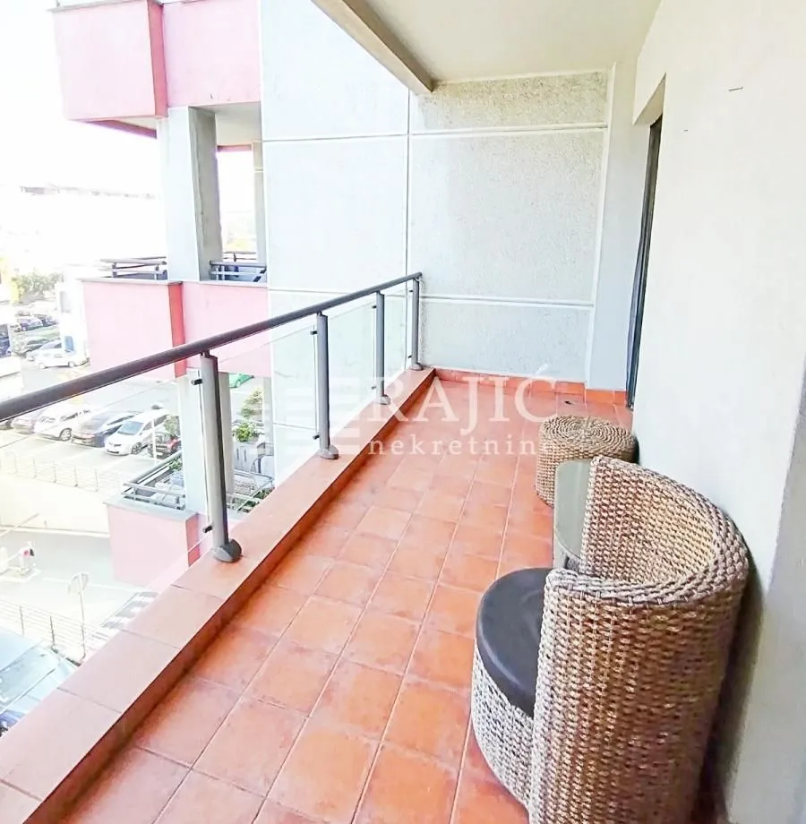 Spacious balcony with seating furniture and a view of the surroundings.