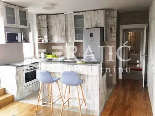 Modern kitchen with a breakfast bar and bar stools.