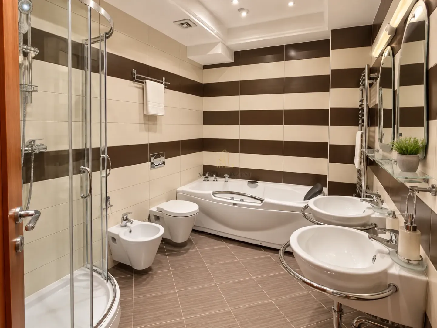 Modern bathroom with a shower cabin, bathtub, and two washbasins.