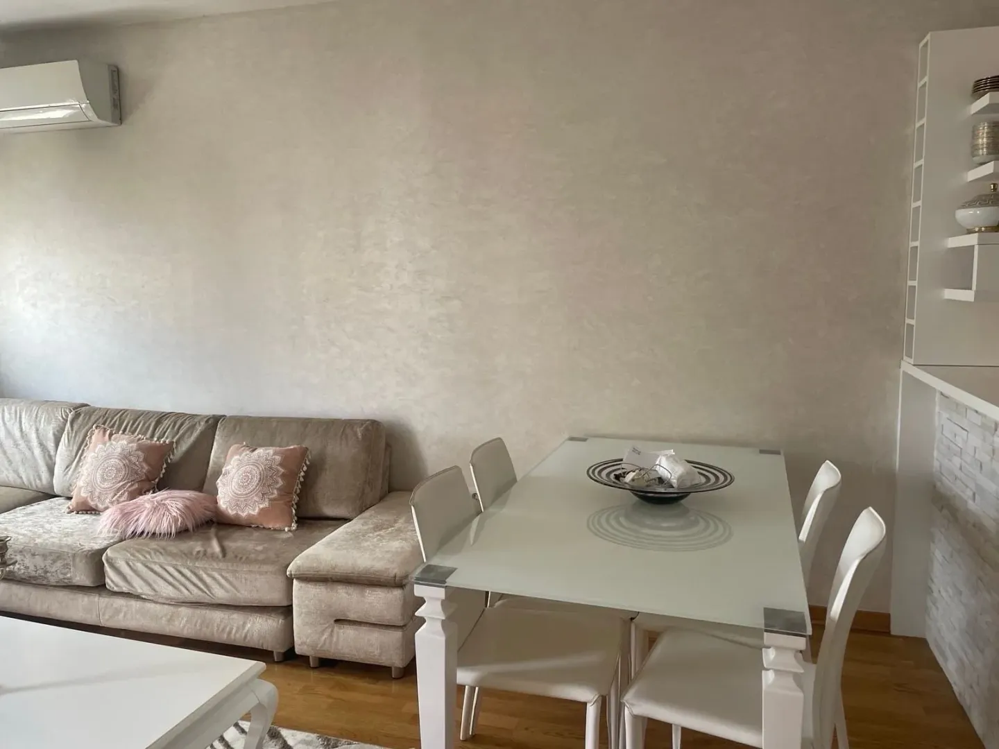 Living room with a sofa and dining table.