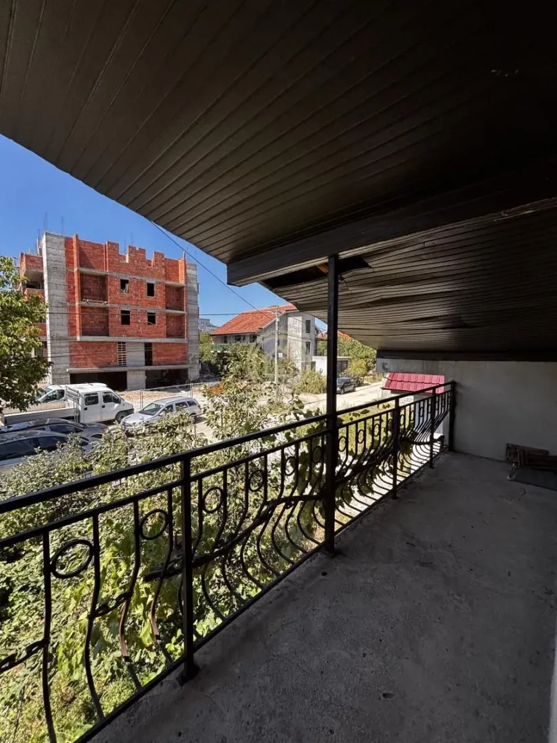 Covered balcony with a view of the street and surrounding buildings.