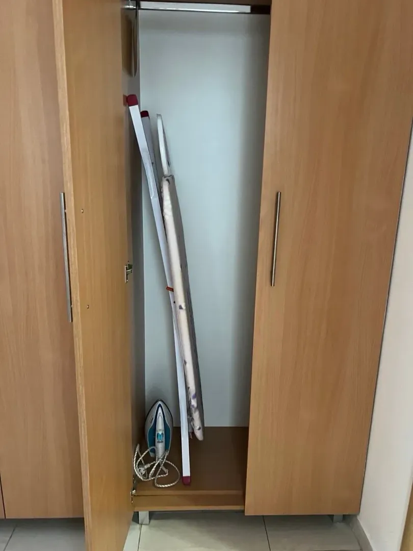 Wooden wardrobe with open doors in the bedroom.