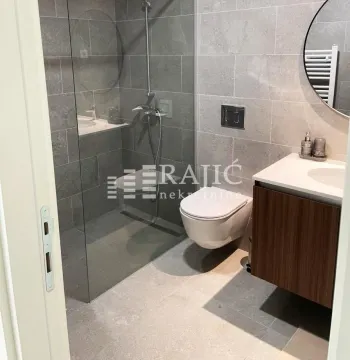Modern bathroom with a walk-in shower and built-in vanity. - image 10