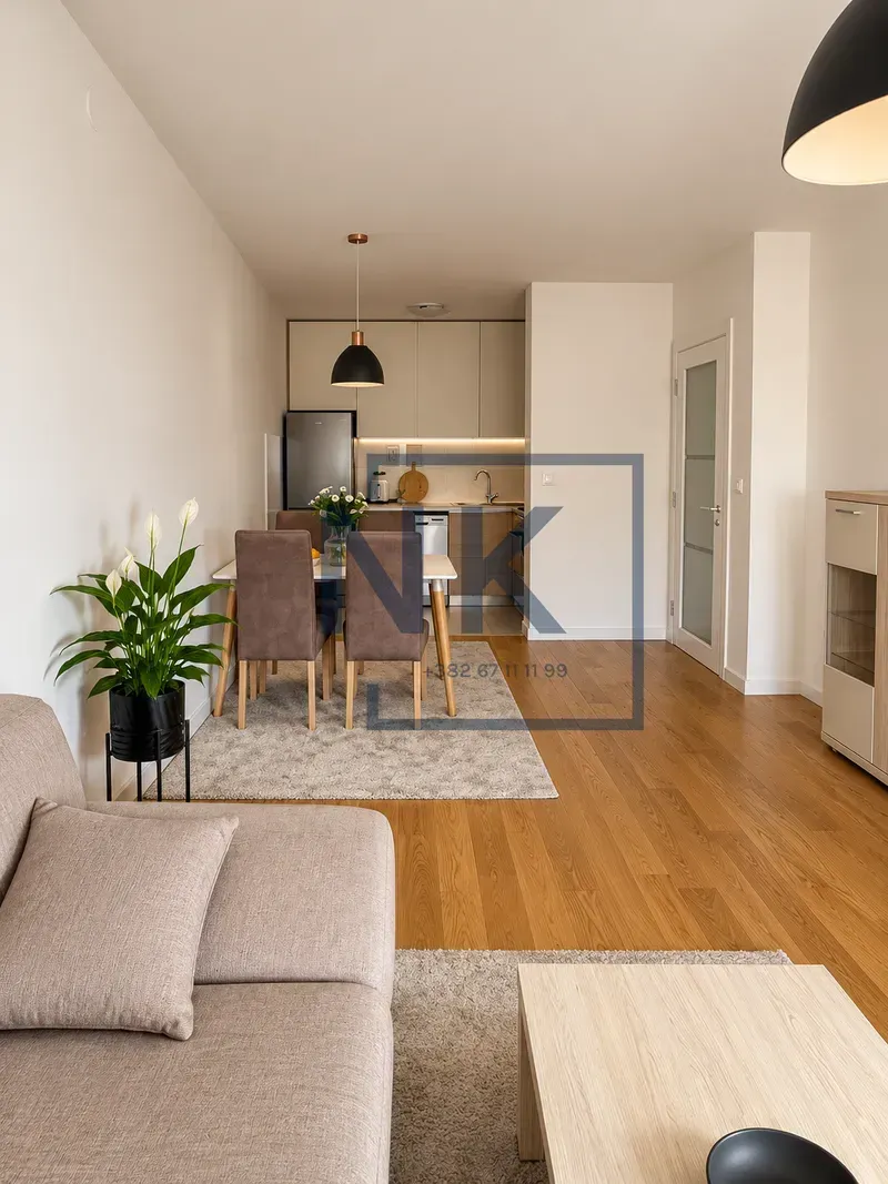 Living room with dining area and kitchen in the background.