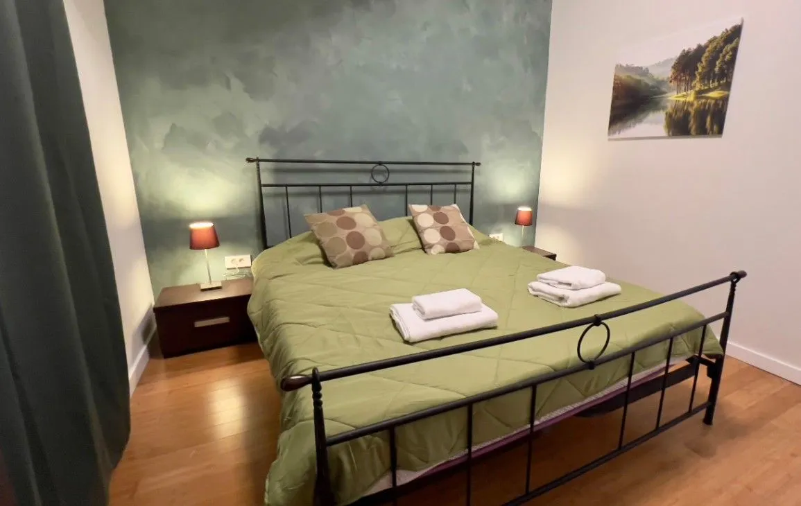 Furnished bedroom with a double bed and bedside tables.