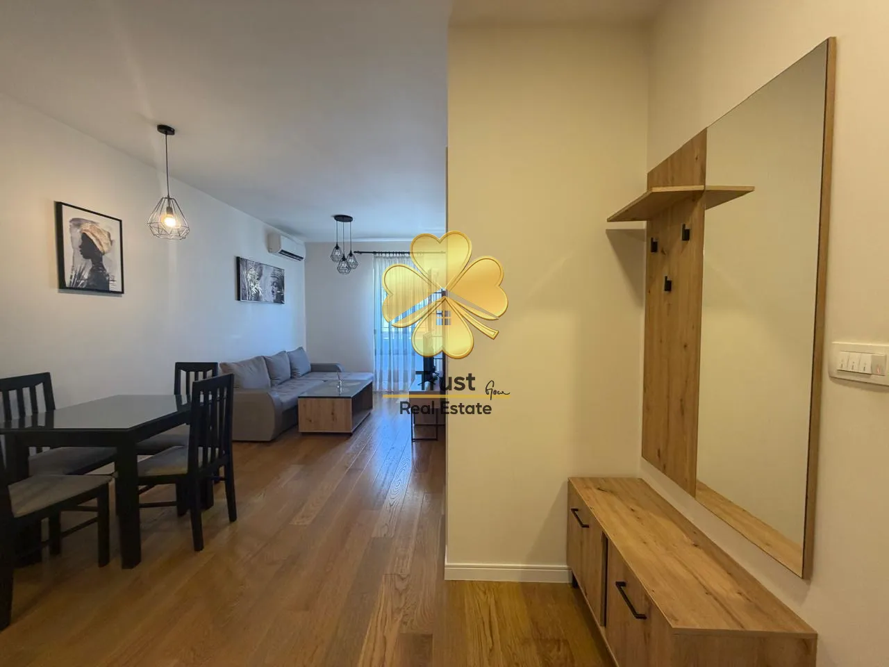 Living room with dining area and hallway in a modern apartment.