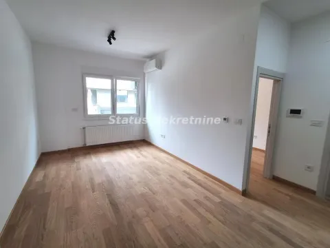 Empty room with wooden flooring, white walls and a window. - image 5