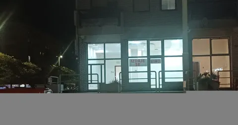 Night view of the exterior of the commercial space with a large glass storefront. - image 11