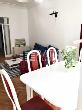 Living room with a dining table and sofa set. - image 3