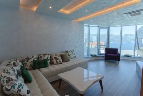 Spacious living room with a sectional sofa, modern ceiling design, and a sea view. - image 6