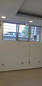 An empty room featuring a window overlooking a parking area. - image 6