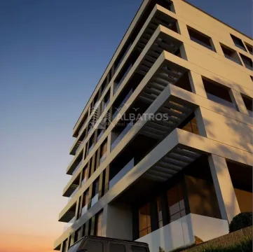 Exterior view of a modern residential building with balconies at dusk. - image 3