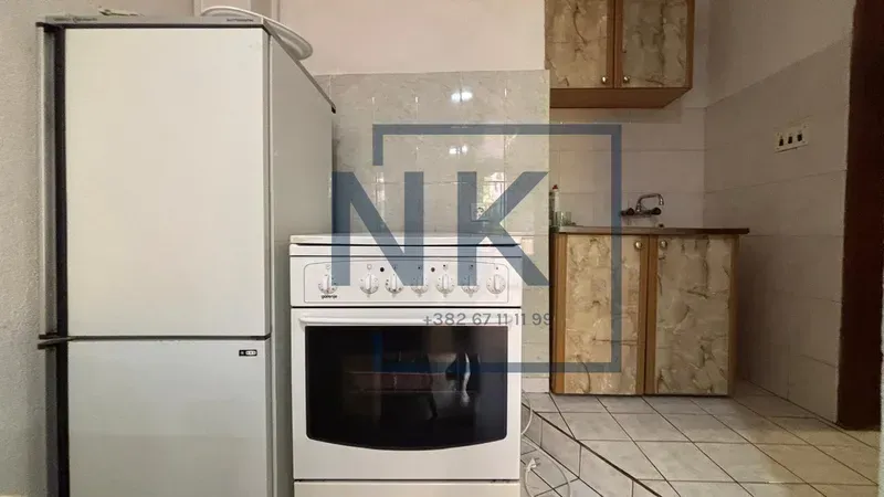 Small kitchen with a refrigerator, stove, and basic cabinetry.