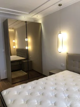 A bedroom featuring a mirrored wardrobe. - image 4
