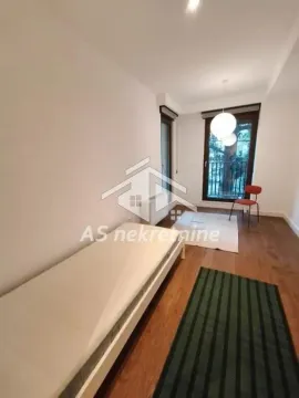 Manja spavaća soba sa krevetom, drvenim podom i balkonskim vratima. - image 19