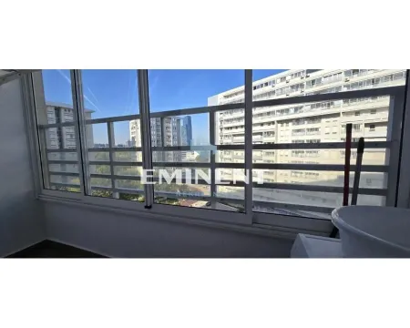 Enclosed balcony with a view of surrounding buildings and neighborhood. - image 20