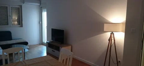 Living room with sofa, TV stand and floor lamp. - image 3