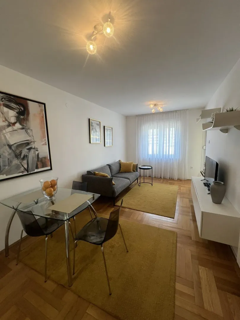 Bright living room with a dining table, seating area, and modern details.
