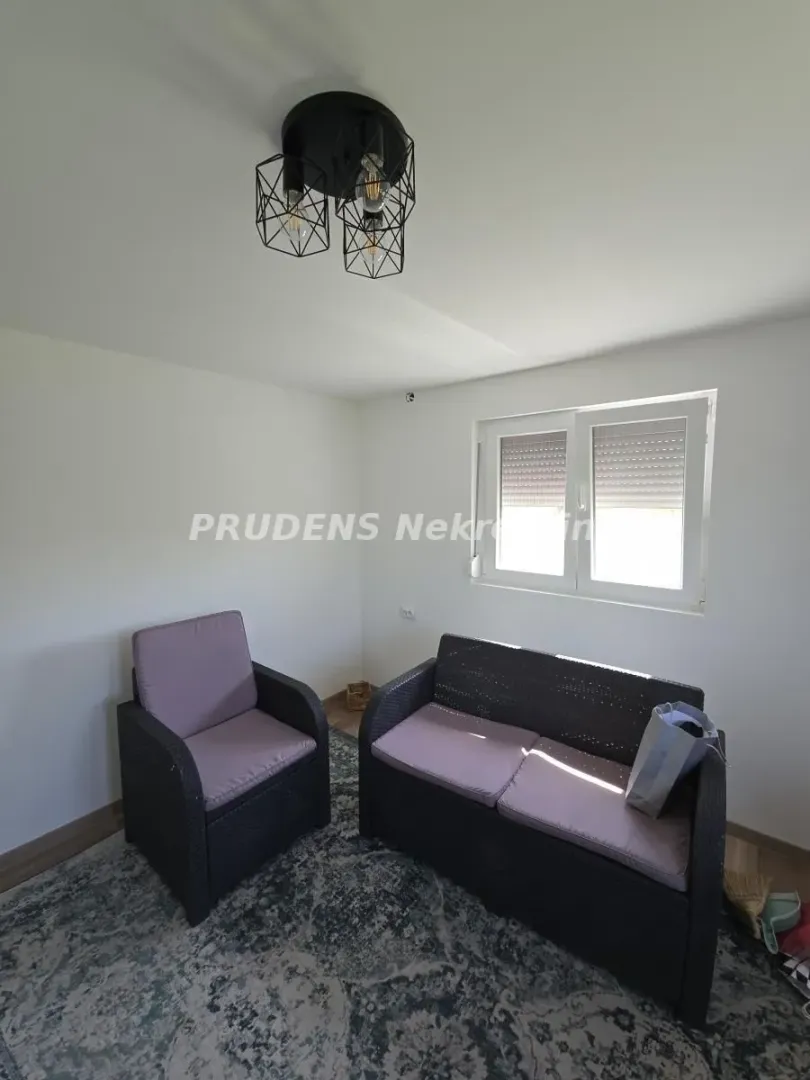 Small living room with seating furniture and a window.
