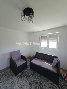 Small living room with seating furniture and a window. - image 15