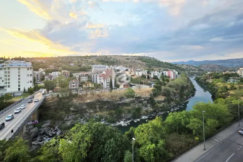 View from the window overlooking the river, city, and distant hills. - image 14