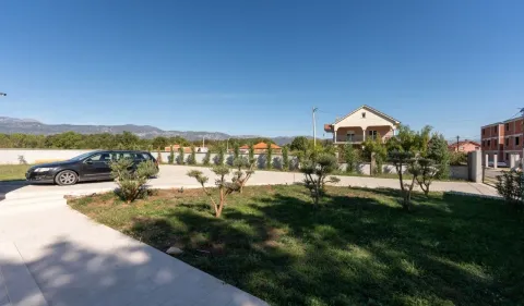 Yard with landscaped lawn, parking space, and view of the surrounding mountains. - image 22
