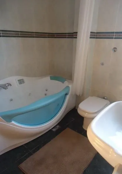 Bathroom with a jacuzzi tub and toilet.