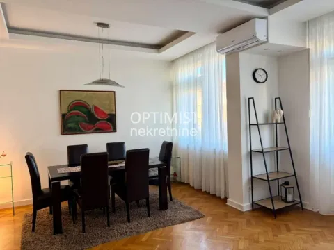 Dining area with a table and black chairs as part of the living room. - image 10