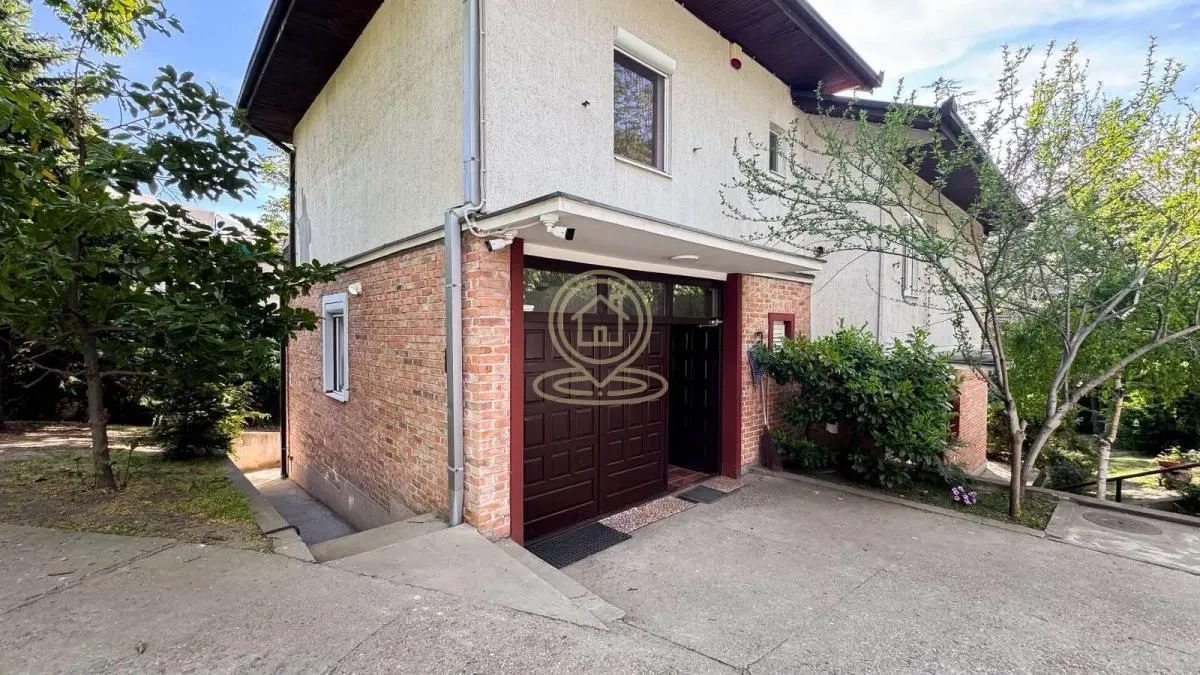 View of the exterior of the house with a yard and garage.