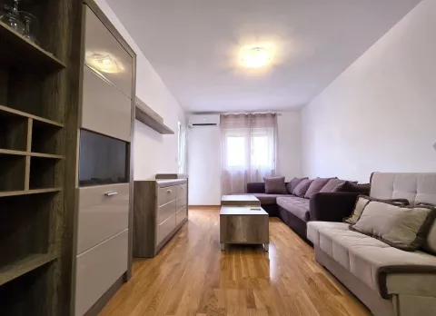 Living room with a sofa set, cabinet furniture and wooden flooring. - image 2
