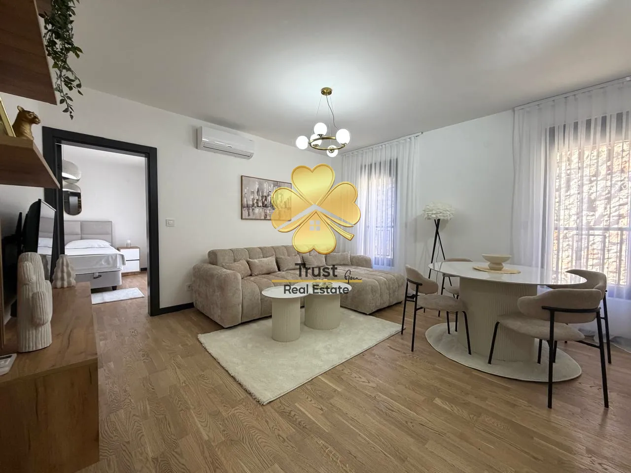 Spacious living room with a sofa and dining table.