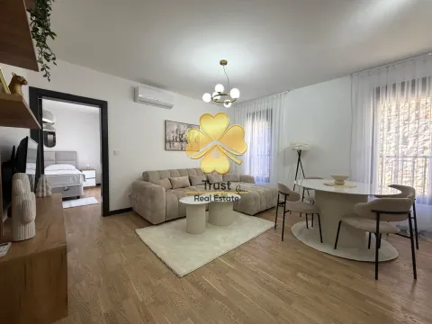 Spacious living room with a sofa and dining table. - image 2