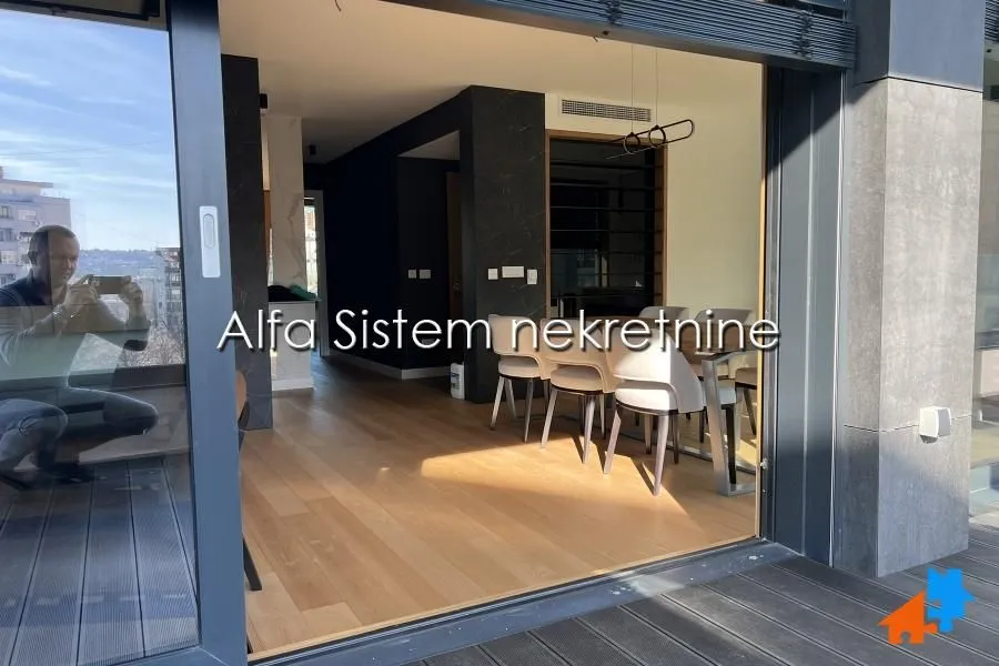 View from the exterior into the interior of a modern living room and dining area.
