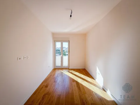 Empty room with hardwood floors and access to a terrace. - image 5