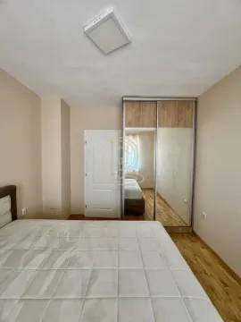 Bedroom with a double bed and a built-in wardrobe with a mirror. - image 12