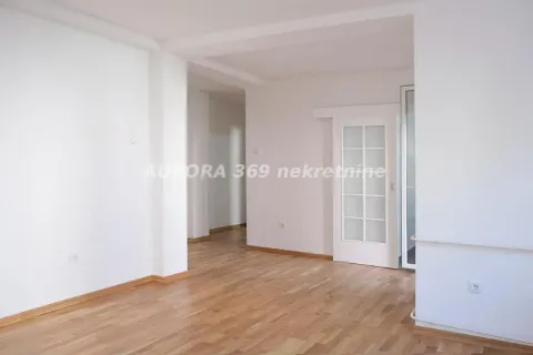 Empty bright room with parquet flooring and white walls. - image 2