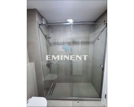 Modern bathroom with a glass walk-in shower. - image 10