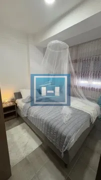 Bedroom with a double bed, bedside table, and a canopy above the bed. - image 13