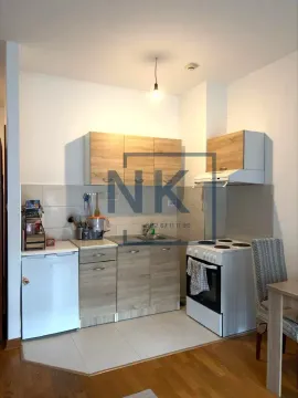 Small kitchen with wooden cabinets, a stove, and a refrigerator. - image 3