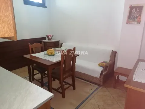 Living room with a dining table and a sofa. - image 13