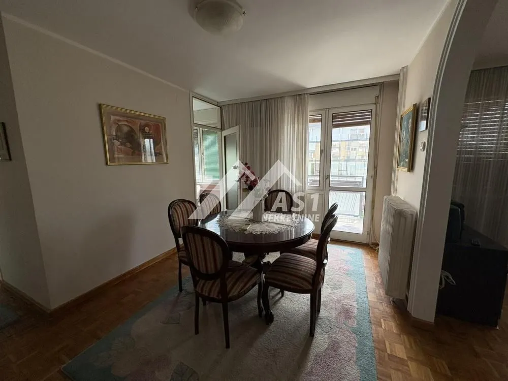 Dining area with a round table and chairs.