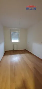 Empty room with hardwood flooring and a single window. - image 6