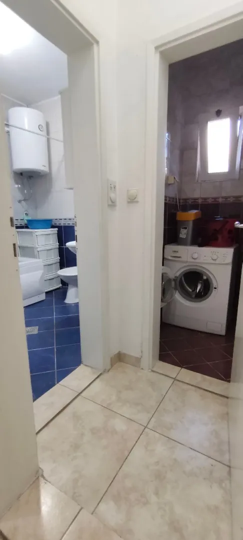 View from the hallway into the bathroom and laundry room.